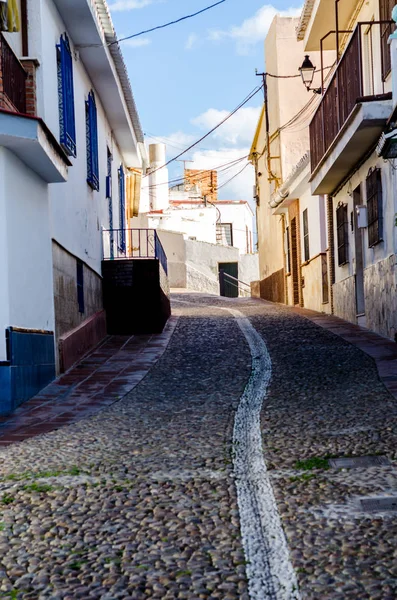 beautiful and picturesque narrow street with white facades of buildings, Spanish architecture, old town