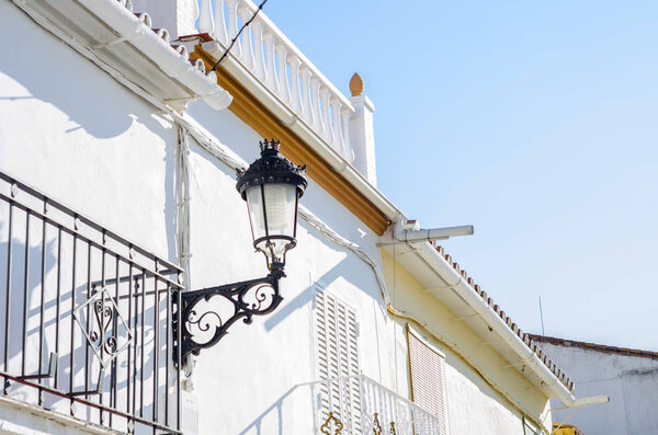 Old stylish street lamp illuminating the Spanish street, a characteristic element of traditional street architecture, decor