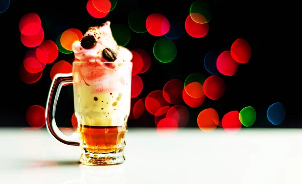 Christmas drink shot in a shot glass on a bokeh background, Christmas decoration on the bar, xmas party