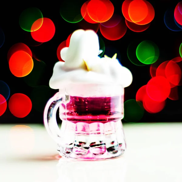 Christmas drink shot in a shot glass on a bokeh background, Christmas decoration on the bar, xmas party