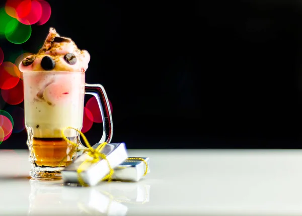 Christmas drink shot in a shot glass on a bokeh background, Christmas decoration on the bar, xmas party