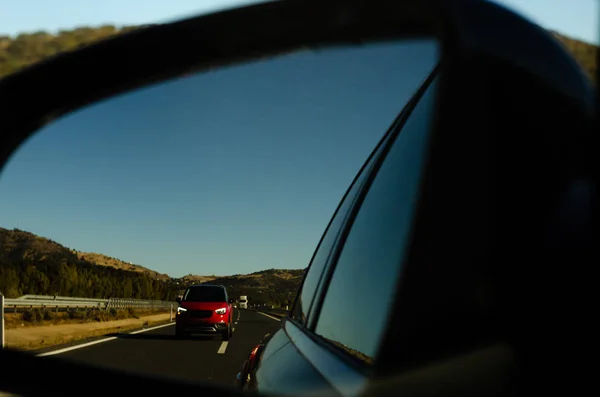 view in the car mirror on fast road in the Spain, beautiful landscape, transportation