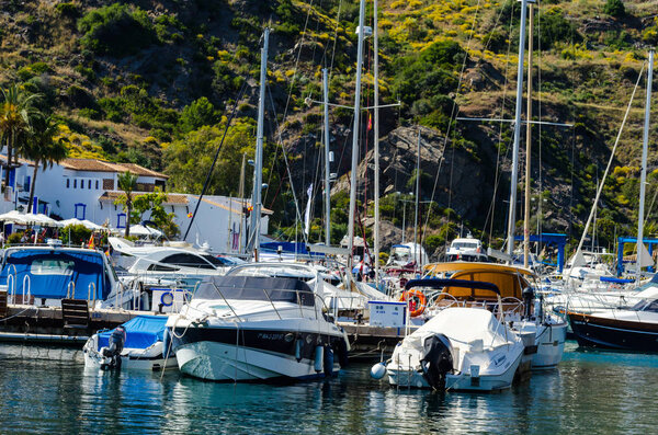 LA HERRADURA, SPAIN - MAY 26, 2018 A beautiful marina with luxury yachts and motor boats in the tourist seaside town of La Herradura