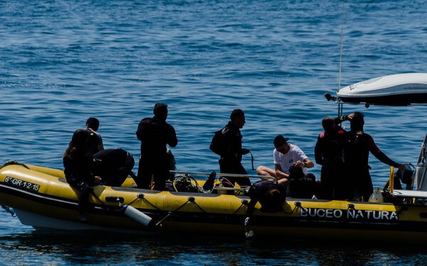 LA HERRADURA, SPAIN - JUNE 14, 2018 People on a pontoon preparing to dive and discover the underwater world, active sport