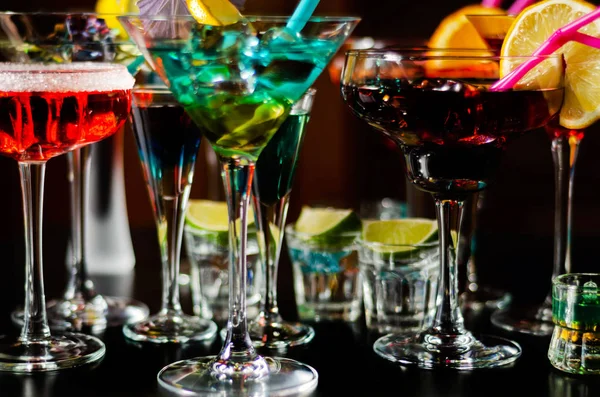Tasty and colorful drinks based on various alcohols, syrups and liqueurs, unique effect of the bartender\'s work, party night