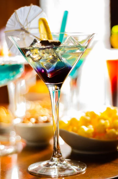 Tasty and colorful drinks based on various alcohols, syrups and liqueurs, unique effect of the bartender\'s work, party night