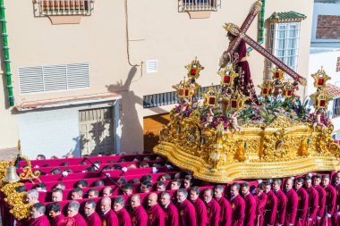 VELEZ-MALAGA, SPAIN - MARCH 29, 2018 People participating in the procession  in the Holy Week in a Spanish city, easter clipart