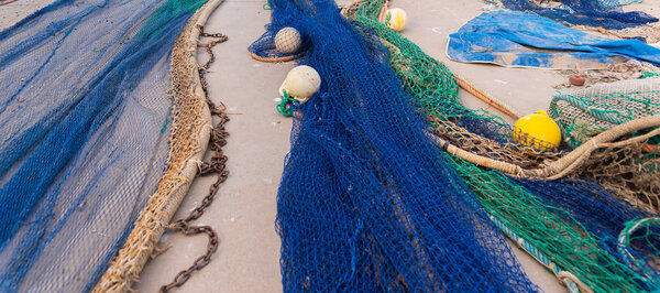 Industrial Fishing Equipment Fishnets and Fishing Lines lying on