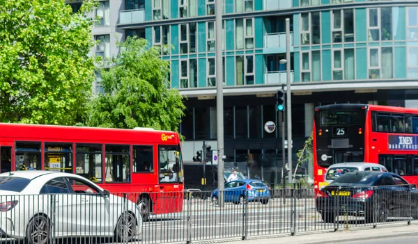 LONDON, UK - MAY 21, 2019 Red double-decker bus driving down the — Stock Photo, Image