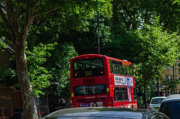 LONDON, UK - MAY 22, 2019 Red double-decker bus driving down the — Stock Photo, Image