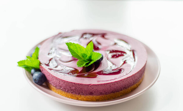 Baked vanilla and berries flavour cheesecake swirled with bluebe