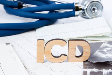 ICD Acronym or abbreviation to implantable cardioverter defibrillator as device that monitors heart rhythm problems. Word ICD is around ECG paper strips, result of echocardiography and stethoscope  clipart