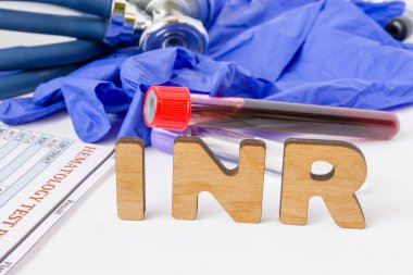 INR Clinical laboratory medical acronym or abbreviation of prothrombin time, blood test for clotting time. Word INR are near laboratory test tubes with blood sample, stethoscope and hematology result clipart