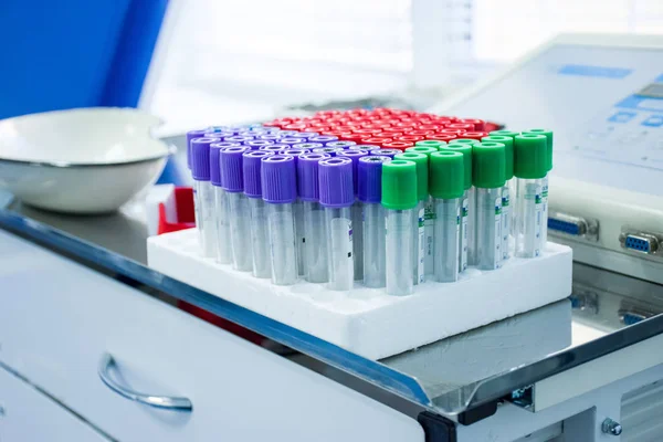 Pencil case with a set of laboratory test tubes for the taking of blood and other biological fluids or sampling is on procedural chrome table in the scientific or clinical laboratory