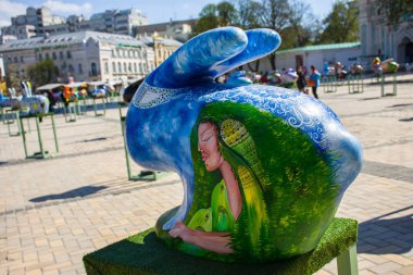 Paskalya şekil mavi renkli kuş üstünde o kadınla boyalı yeşil orman tavşan ya da tavşan. Güzel Paskalya sanat dekorasyon