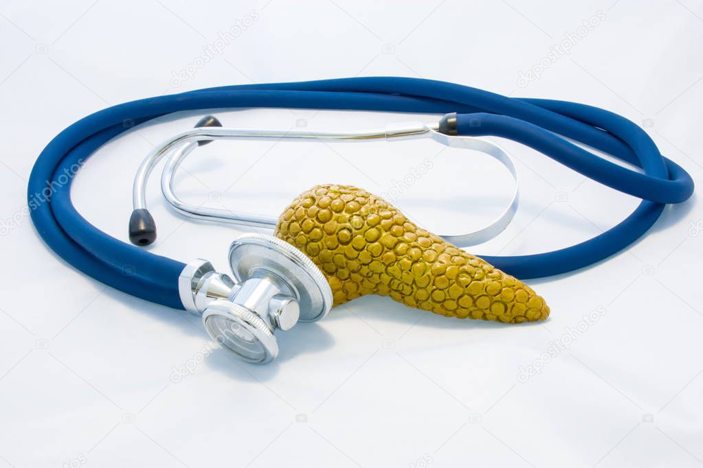 Pancreas gland is next to stethoscope and his head, symbolizing process of diagnosis of pancreas diseases, identify causes of increase or decrease production of hormones and other endocrine problems