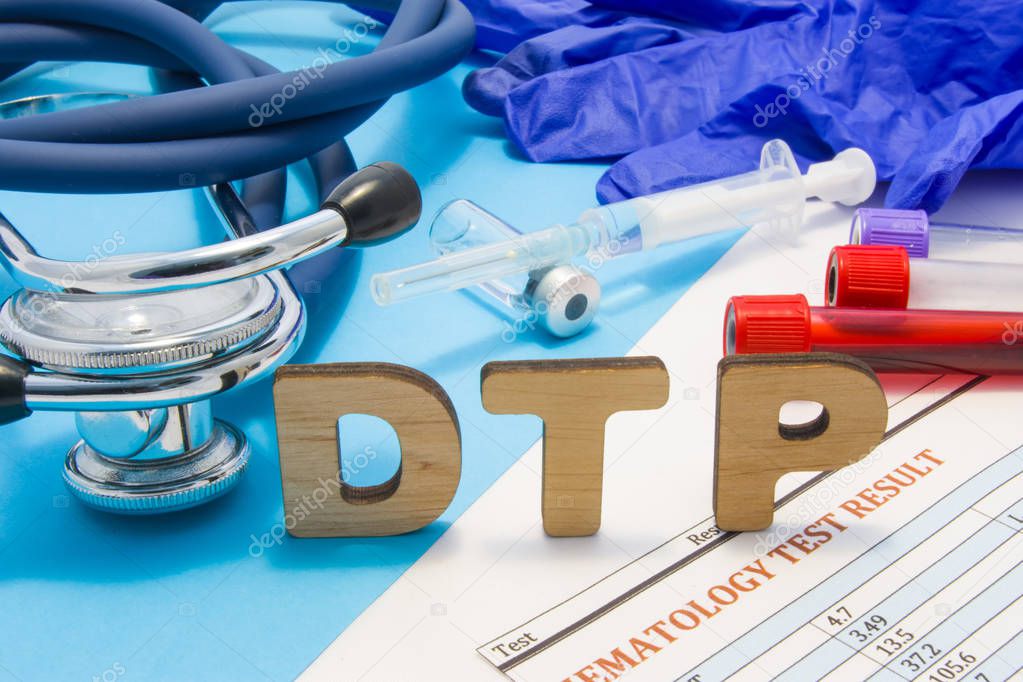 Concept photo DTP (or DPT) - diphtheria, tetanus, pertussis - vaccine or vaccination process of children. Abbreviation DTP is against background of ampoule with vaccine, syringe, stethoscope, blood