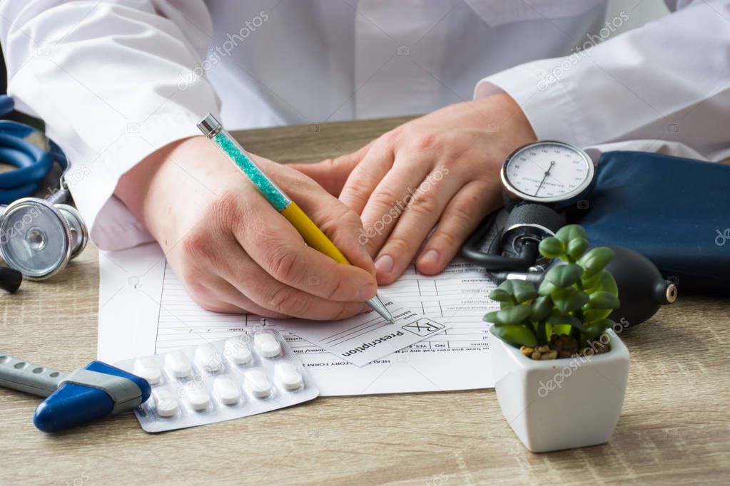 Doctor in hospital office prescribe prescription medication to patient who came to appointment. Control and monitoring of discharge of prescription drugs for pharmacotherapy pharmaceutical treatment