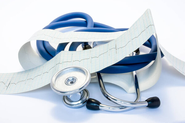 Diagnosis, treatment and prevention of diseases of heart and cardiovascular system concept photo. Blue stethoscope is surrounded by tape of ECG with electrocardiogram drawn on it. Diagnosis of disease