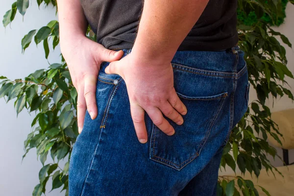 The manifestation of pain in the hip joint concept photo. The man grabbed his upper thigh where the hip joint due to sudden pain symptoms in it. Symptoms of novice of arthritis or coxarthrosis — Stock Image Manifestation Pain Hip Joint Concept Photo Man Grabbed His Upper Royalty Free Stock Images