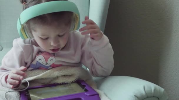 Маленька Дівчинка Читає Книгу Свого Планшета — стокове відео