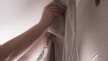 Adım adım. Perdeler perdeler yeni evinde yatak odasında asılı kadın.