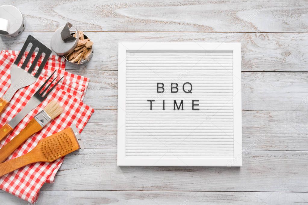 BBQ Time sign on memo board with BBQ tools.