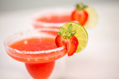 Taze çilek margarita kokteyl taze çilek ve kireç ile süslenmiş.