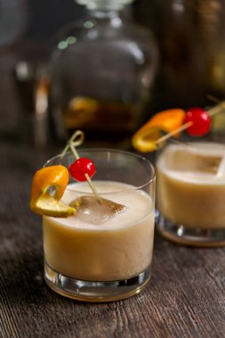 Viski kokteyli kokteyl portakal ve vişne ile süslenmiş.