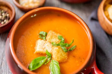 Taze fesleğen ve kruton ile kavrulmuş domates çorbası.