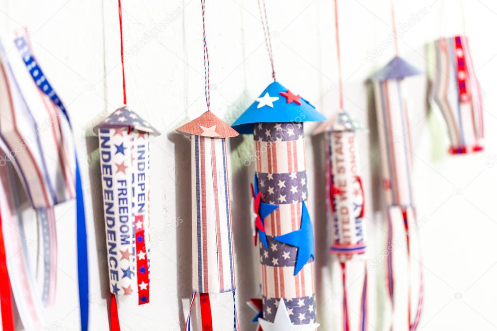 Paper firecrackers made from red, white and blue paper for July 4th celebration.