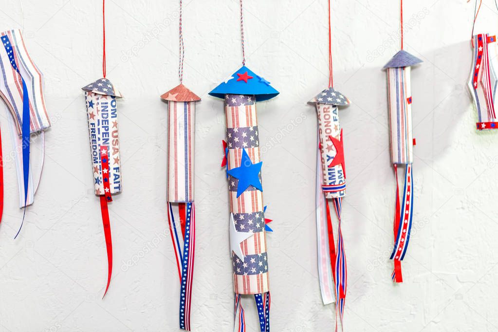 Paper firecrackers made from red, white and blue paper for July 4th celebration.