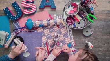 Anne ve kızı kağıt havai fişek yapma ileri geri 4 Temmuz kutlamaları.