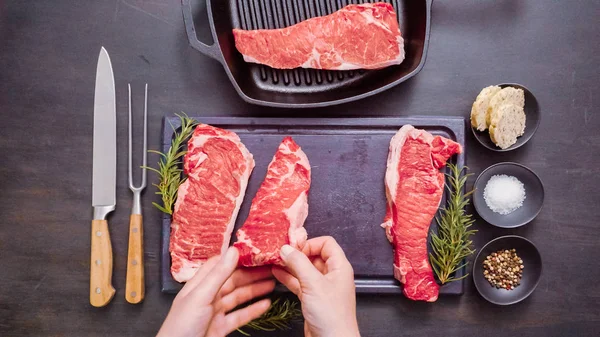 Dökme demir tavada ham New York şerit biftek.