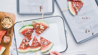 Adım adım. Karpuz dilimleri çikolata ve deniz ile süslenmiş Tepsi hizmet veren demir çubuk üzerinde tuz.