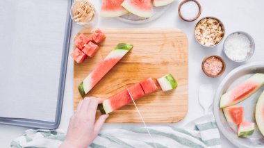 Çikolata kaplı karpuz hazırlanması için küpler halinde karpuz Dilimleme ısırıkları.