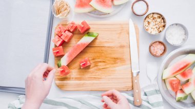 Çikolata kaplı karpuz hazırlanması için küpler halinde karpuz Dilimleme ısırıkları.