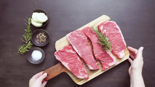 Raw New York Strip Steaks Wood Cutting Board — Stock Video