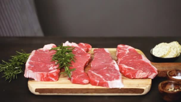 Rauw New York Strip Steaks Een Houten Snijplank — Stockvideo