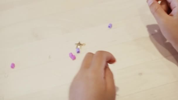 Close Kids Hands Stringing Colorful Beads Make Bracelet — Stock Video
