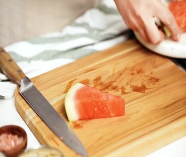 Çikolata ve sprinked deniz tuzu ve badem ile karpuz mezeler hazırlamaya küpleri karpuz Dilimleme daldırma