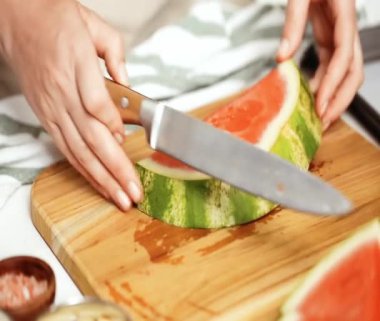 Çikolata ve sprinked deniz tuzu ve badem ile karpuz mezeler hazırlamaya küpleri karpuz Dilimleme daldırma