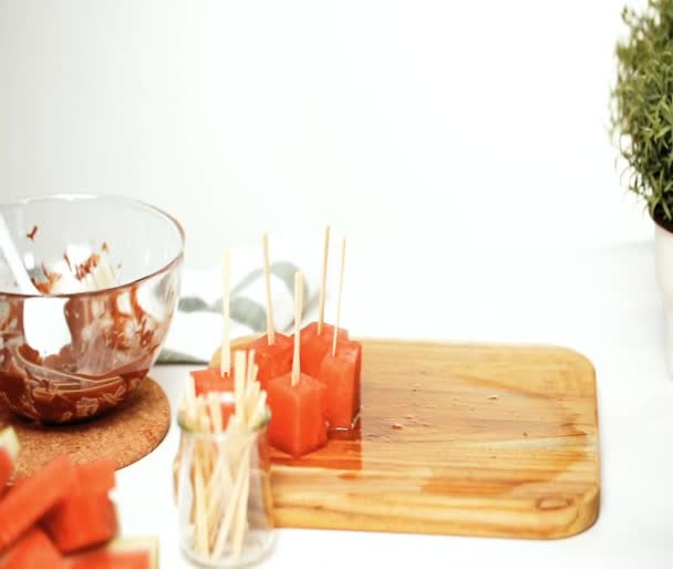 Dipping Watermelon Cubes Melted Chocolate Garnishing Sea Salt Almonds — Stock Video