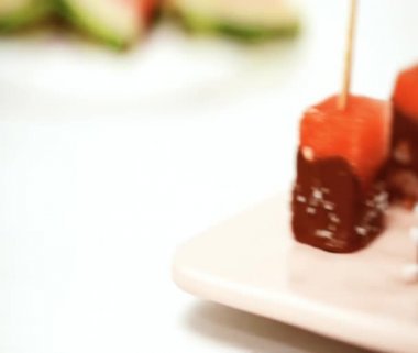 karpuz küpleri içinde eritilmiş çikolata ve deniz tuzu ve badem ile süsleme.