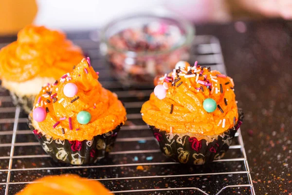 Decorating Orange Icing Cupcakes Sprinkle Mix Royalty Free Stock Photos