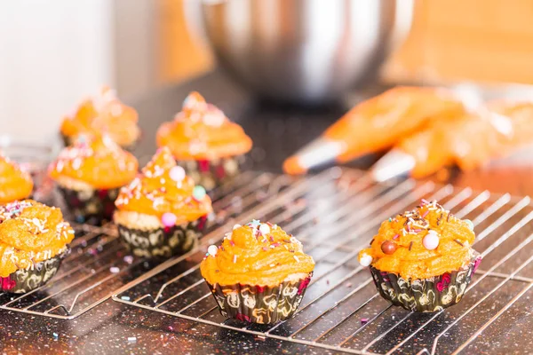 Decorating Orange Icing Cupcakes Sprinkle Mix Royalty Free Stock Photos