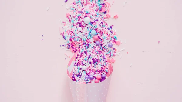 stock image Colorful purple sprinkle blend on a pink background.