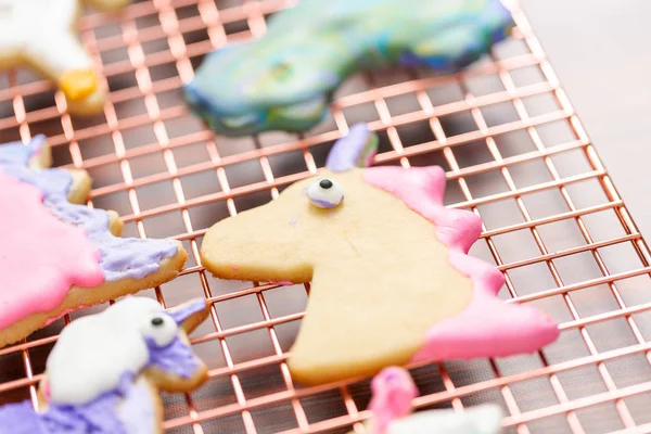 Tek boynuzlu at raf kurutma üzerinde Kraliyet buzlanma ile çocuklar tarafından dekore edilmiş şekerli kurabiye şeklinde.