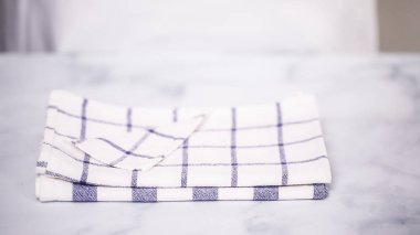 Mermer yüzey üzerinde mavi ve beyaz desenli kağıt havlu katlama.