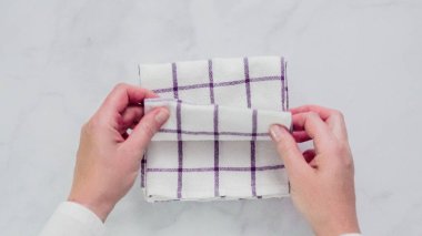 Mermer yüzey üzerinde mavi ve beyaz desenli kağıt havlu katlama.